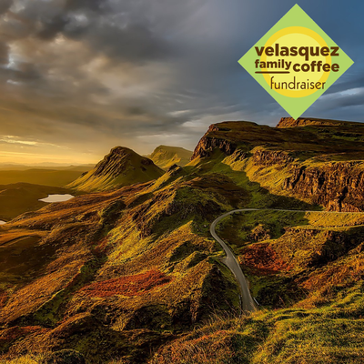 Mountain landscape with a winding road and Velasquez Family Coffee fundraiser logo overlay, Butterscotch crème and rich hazelnut flavored coffee
