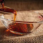 Velasquez Family Coffee Maple Almond Scone flavored coffee image of pouring maple syrup