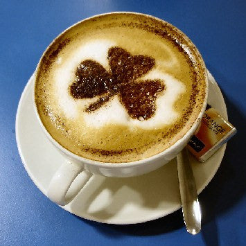 Coffee cup on a saucer cream with three leaf clover design Drunken Uncle holiday coffee Kahlua, Irish Cream , Grand Marnier