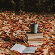 Images shows Fall leaves, stack of books and a coffee cup. This flavor celebrates the fall flavors of nutmeg, cinnamon and spice